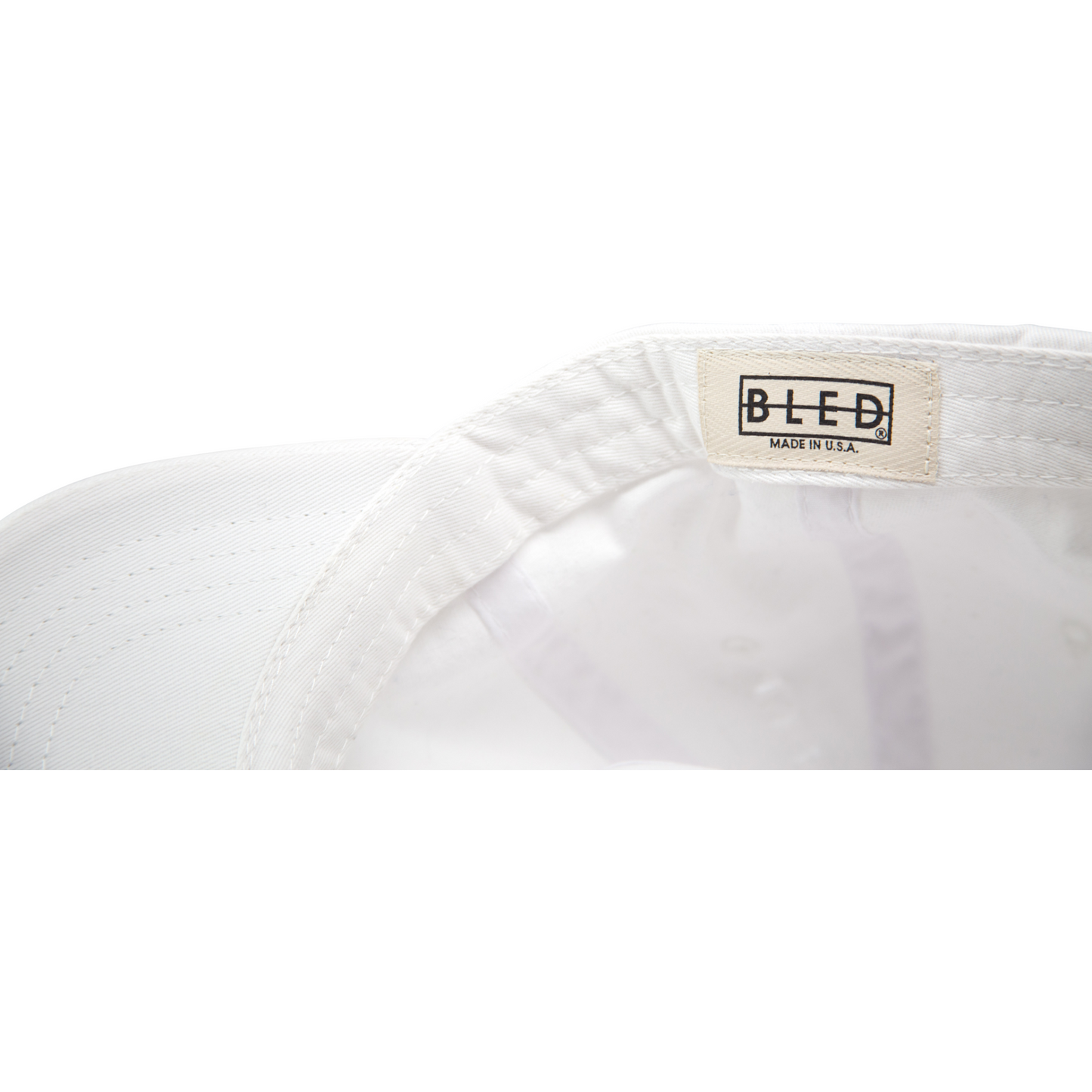 6-panel unconstructed 100% Cotton white dad hat featuring Levels design embroidery on the front and Bled logo embroidered on the back with adjustable strap closure.