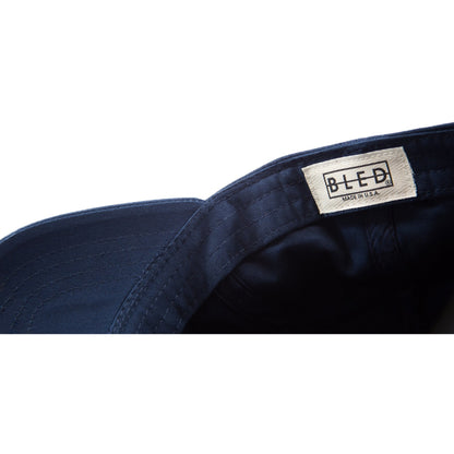 6-panel unconstructed Cotton navy dad hat featuring BLED letter logo felt patch on the front and BLED logo embroidered on the back with adjustable strap closure. skate, skateboarding, hype, streetwear
